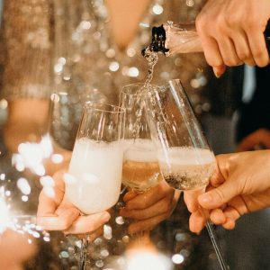person-pouring-champagne-on-champagne-flutes-3171770